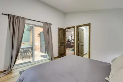 a bedroom with a bed and a view of a patio at Walk to Water Park Split-Rock Resort Home with Deck in Lake Harmony