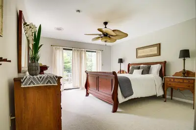 a bedroom with a bed and a ceiling fan at 3 Mi to Downtown Inviting Lancaster Home! in Lancaster