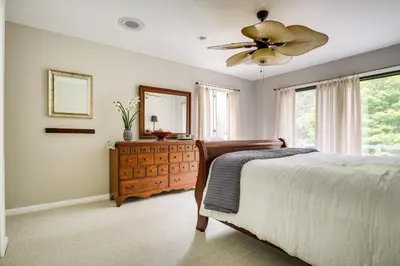 a bedroom with a bed and a mirror and a dresser at 3 Mi to Downtown Inviting Lancaster Home! in Lancaster