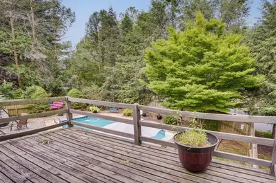 a porch with a potted plant on a wooden deck at 3 Mi to Downtown Inviting Lancaster Home! in Lancaster