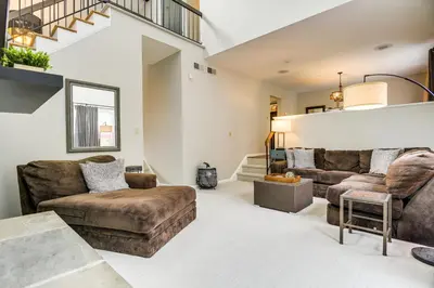 a living room with two couches and a staircase at 3 Mi to Downtown Inviting Lancaster Home! in Lancaster