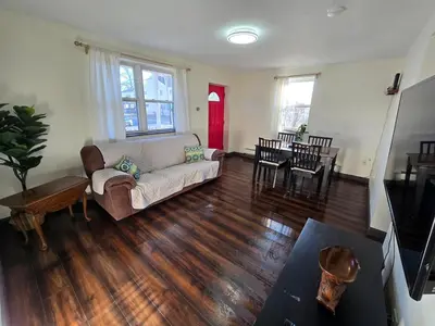 a living room with a couch and a table at RentalsOP NJ01 Full house minutes from NYC, near to metlife, American Dream in Hackensack