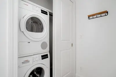 a laundry room with a washer and dryer next to a door at Midtown East 1br w doorman nr Grand Central NYC-1170 in New York