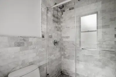 a bathroom with a glass shower with a toilet at Midtown East 1br w doorman nr Grand Central NYC-1170 in New York