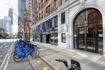 a row of blue bikes parked in front of a building at Midtown East 1br w doorman nr Grand Central NYC-1170 in New York