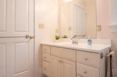 a bathroom with a white sink and a mirror at Dutch Country Acres in New Providence