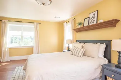 a bedroom with a white bed and a window at Dutch Country Acres in New Providence
