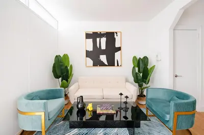 a living room with two blue chairs and a white couch at 444-3F Newly renovated 1BR in Hell's Kitchen in New York