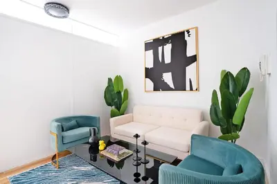 a living room with two blue chairs and a white couch at 444-3F Newly renovated 1BR in Hell's Kitchen in New York