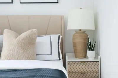 a bedroom with a bed with a lamp and pillows at 444-3F Newly renovated 1BR in Hell's Kitchen in New York