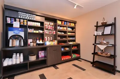 a store with a counter with products on shelves at Candlewood Suites Sayre by IHG in Sayre