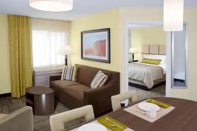 a hotel room with a couch and a bed at Candlewood Suites Sayre by IHG in Sayre