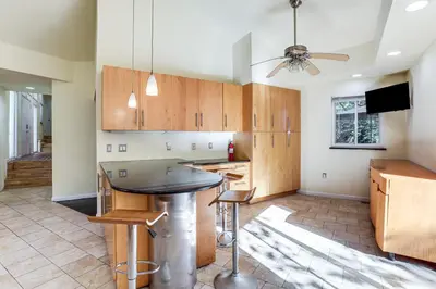 a kitchen with a table and a ceiling fan at Spacious King of Prussia Home with 2 Game Rooms in King of Prussia