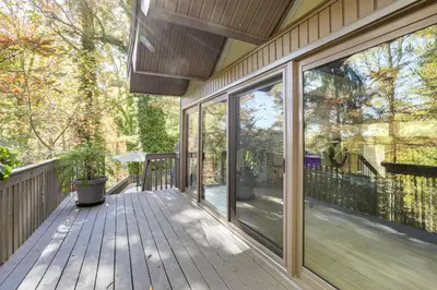 a deck with sliding glass doors on a house at Spacious King of Prussia Home with 2 Game Rooms in King of Prussia