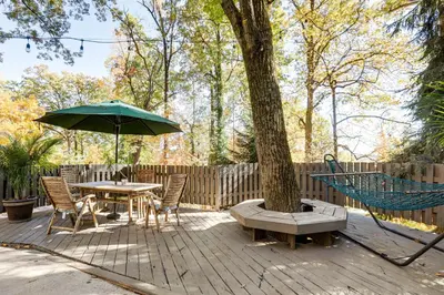 a patio with a table and an umbrella and chairs at Spacious King of Prussia Home with 2 Game Rooms in King of Prussia