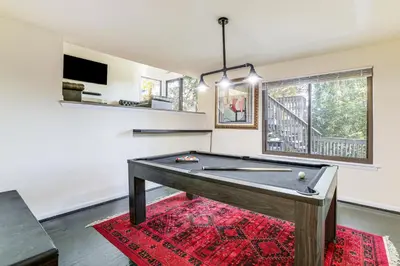 a ping pong table in a living room with at Spacious King of Prussia Home with 2 Game Rooms in King of Prussia