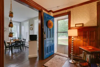 a room with a blue door and a dining room at Historic Home on Farm, 15 Mi to Williamsport! in Antes Fort