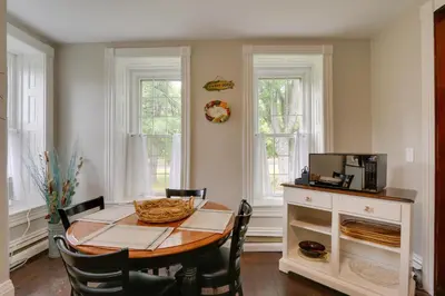 a dining room with a table and chairs at Historic Home on Farm, 15 Mi to Williamsport! in Antes Fort