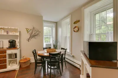 a dining room with a table and chairs and a television at Historic Home on Farm, 15 Mi to Williamsport! in Antes Fort