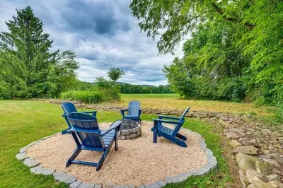 three blue chairs and a table in a yard at Historic Home on Farm, 15 Mi to Williamsport! in Antes Fort