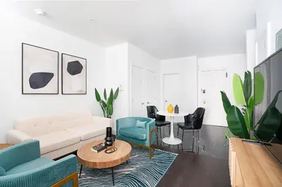 a living room with a couch and chairs and a table at 444-2C Newly renovated 1BR in Hell's Kitchen in New York