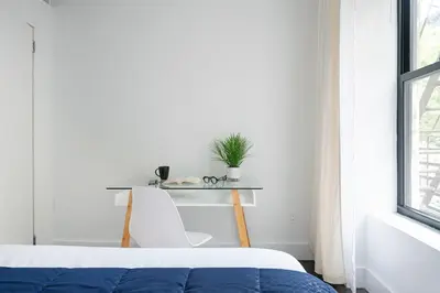 a bedroom with a bed and a desk with a plant at 444-4F Newly renovated 1BR in Midtown West in New York