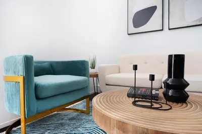 a living room with a blue chair and a coffee table at 444-4F Newly renovated 1BR in Midtown West in New York