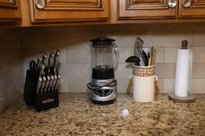 a blender sitting on a kitchen counter with utensils at Family 3-bedroom home (2nd floor near EWR/Outlet) in Elizabeth
