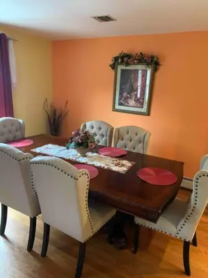 a dining room table with chairs and a table and ahibition at Family 3-bedroom home (2nd floor near EWR/Outlet) in Elizabeth