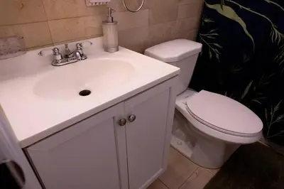 a bathroom with a white sink and a toilet at Family 3-bedroom home (2nd floor near EWR/Outlet) in Elizabeth