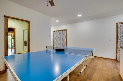a ping pong table in the middle of a room at Secluded Marathon Hideaway with Fire Pit and Views! in Marathon