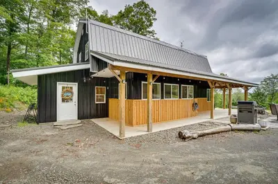 a small black house with a white door at Secluded Marathon Hideaway with Fire Pit and Views! in Marathon