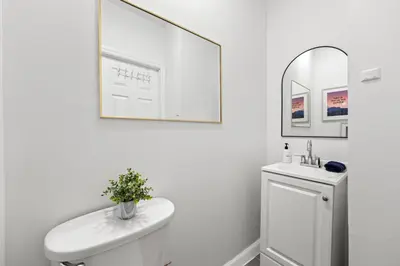 a bathroom with a sink and a toilet and a mirror at Convenient 2BR - Walking distance to Times Square in New York
