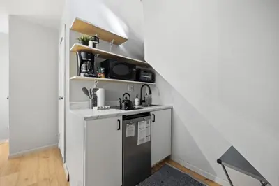 a small kitchen with a sink and a stove at Studio Haven in Times Square & Nearby Restaurants in New York