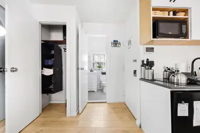 a small white kitchen with a sink and a stove at Midtown Studio - Walking Distance to Times Square in New York