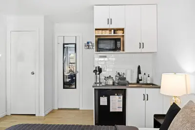 a kitchen with white cabinets and a counter top at Midtown Studio - Walking Distance to Times Square in New York