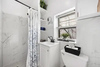 a white bathroom with a sink and a toilet at Midtown Studio - Walking Distance to Times Square in New York