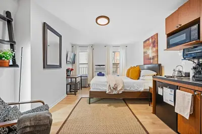 a living room with a bed and a kitchen at Times Square Studio near Restaurants & Shopping in New York