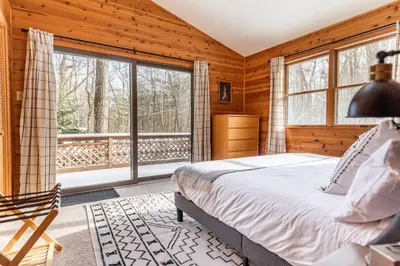 a bedroom with a bed and a large window at Luxe Lake Harmony Home, Game Room, Firepit, Deck in Spilt Rock