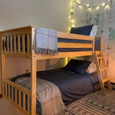 a wooden bunk bed with a small bed underneath it at Luxe Lake Harmony Home, Game Room, Firepit, Deck in Spilt Rock