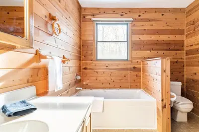 a bathroom with a tub and a toilet at Luxe Lake Harmony Home, Game Room, Firepit, Deck in Spilt Rock