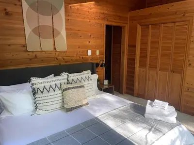 a bedroom with a bed with white sheets and pillows at Luxe Lake Harmony Home, Game Room, Firepit, Deck in Spilt Rock