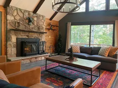 a living room with a couch and a fireplace at Luxe Lake Harmony Home, Game Room, Firepit, Deck in Spilt Rock