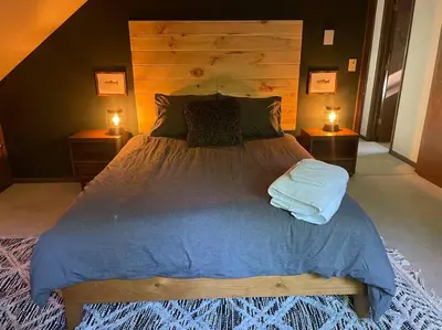 a bedroom with a large bed with two night stands at Luxe Lake Harmony Home, Game Room, Firepit, Deck in Spilt Rock