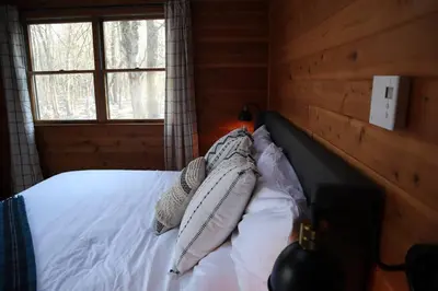 a bedroom with a bed with white sheets and pillows at Luxe Lake Harmony Home, Game Room, Firepit, Deck in Spilt Rock