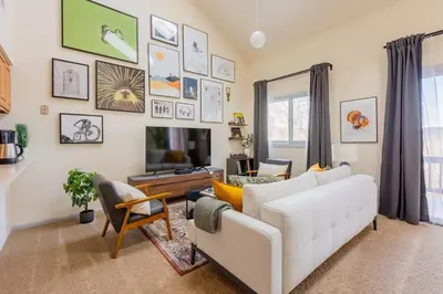 a living room with a white couch and a tv at Cozy 2BR condo w/ valley views in Vernon Township