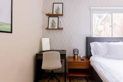 a bedroom with a desk and a bed and a chair at Cozy 2BR condo w/ valley views in Vernon Township