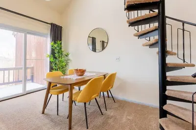 a dining room with a table and yellow chairs at Cozy 2BR condo w/ valley views in Vernon Township