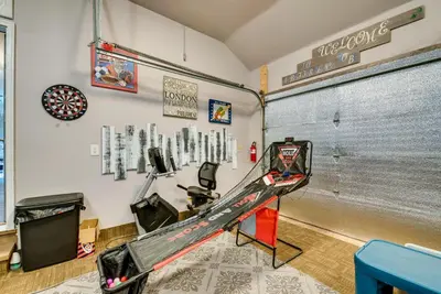 a room with a racing bike on a wall at Hot Tub, Game Room and Fire Pit Pocono Summit Home! in Pocono Summit