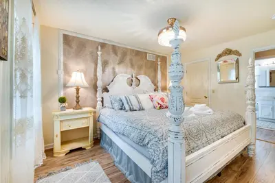 a bedroom with a blue and white bed and a lamp at Hot Tub, Game Room and Fire Pit Pocono Summit Home! in Pocono Summit